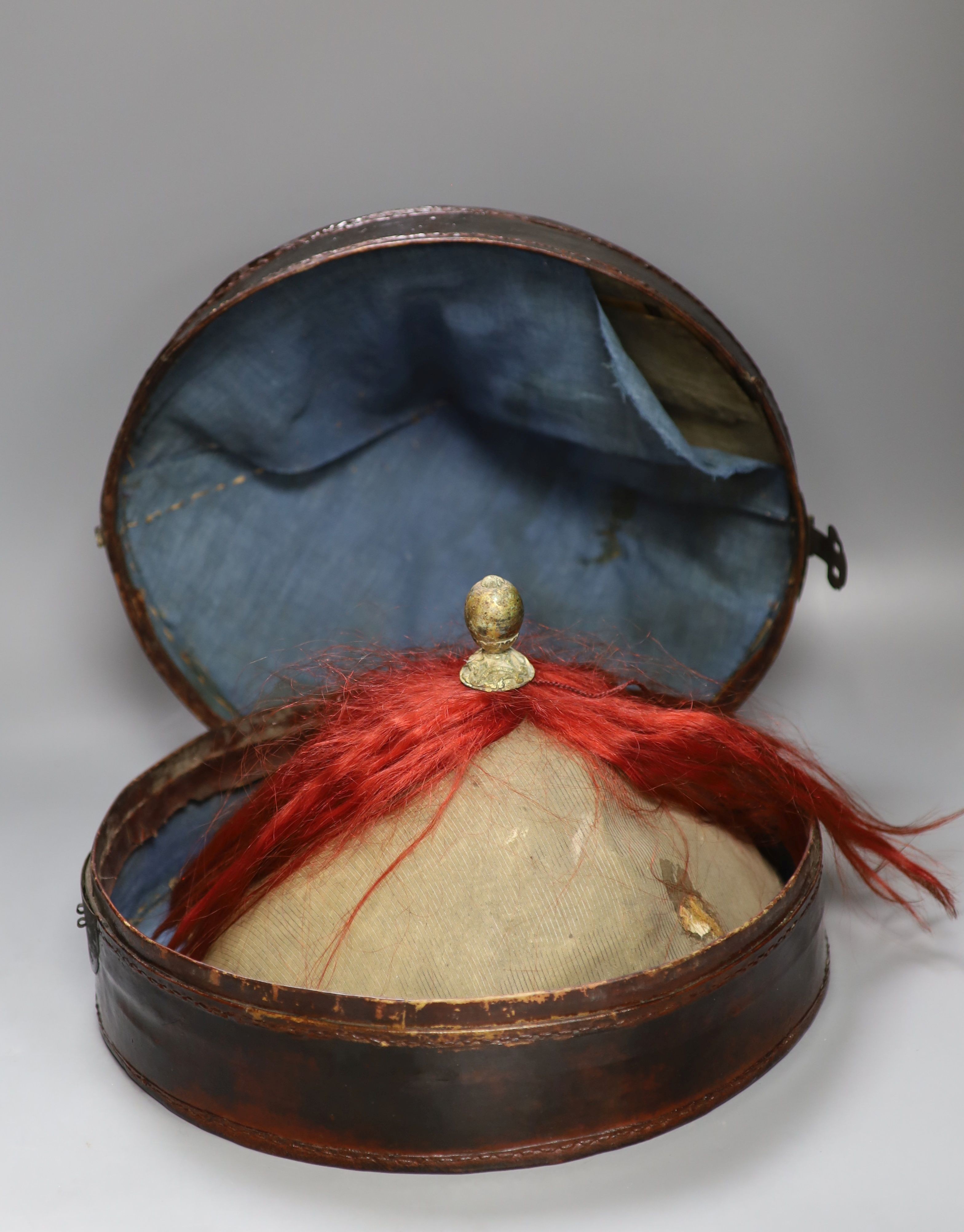 A Chinese late Qing mandarin hat, with gilt finial and original hide case